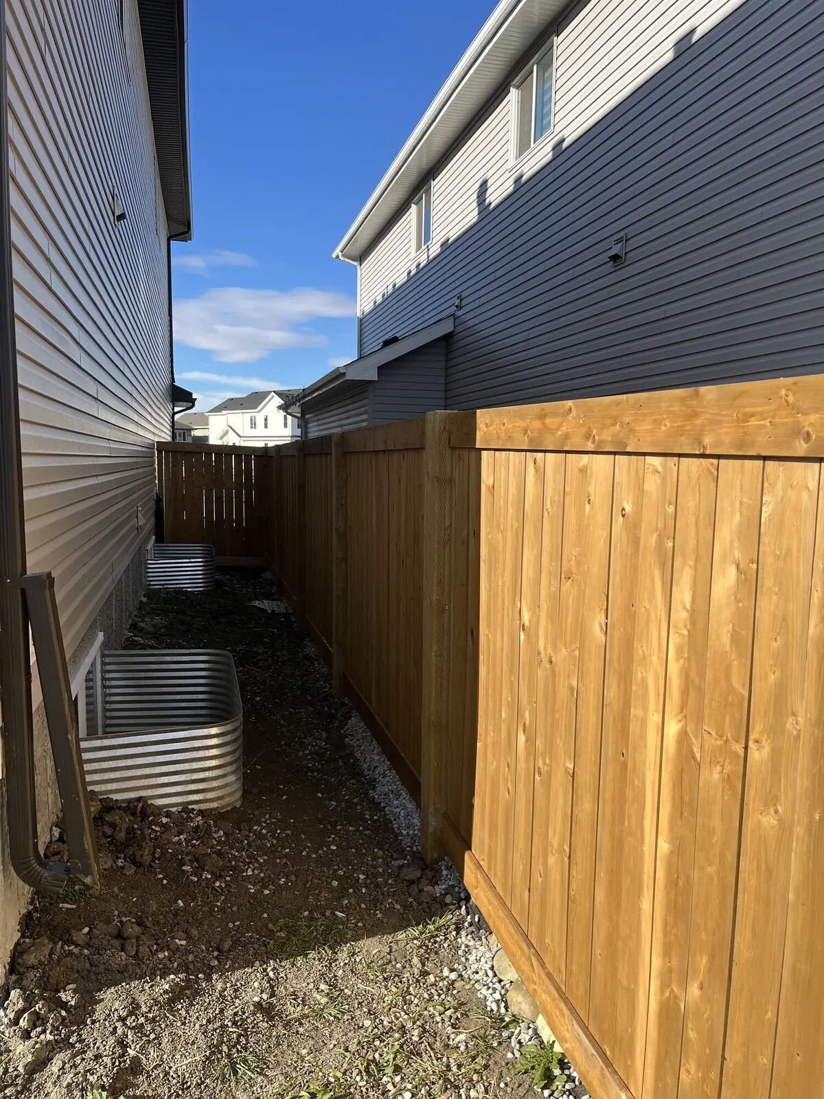 New cedar privacy fence and gate along a narrow side yard